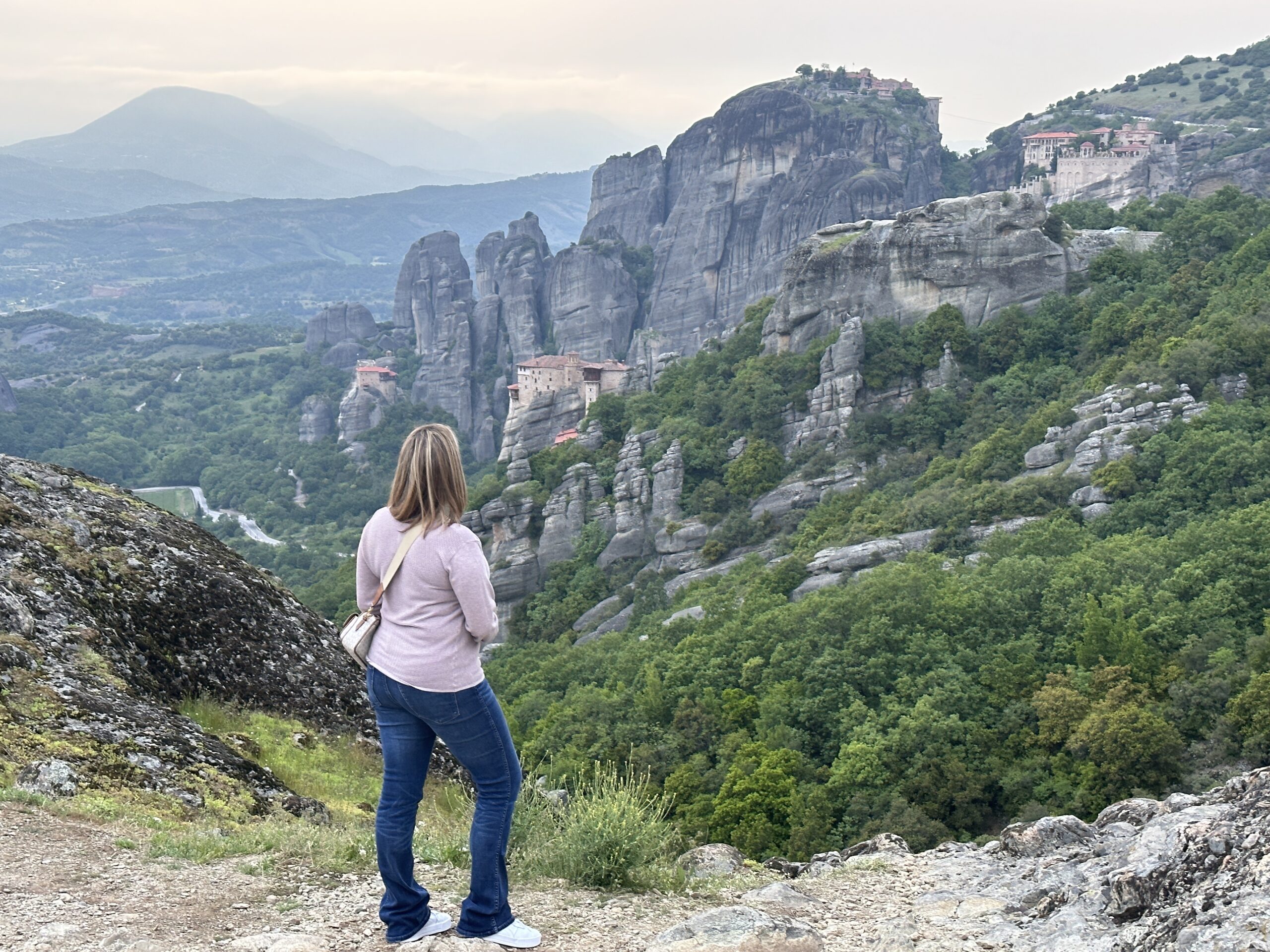 woman looking at out Meteora and its monasteries